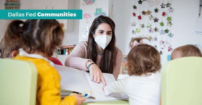 Preschool teacher helping students read