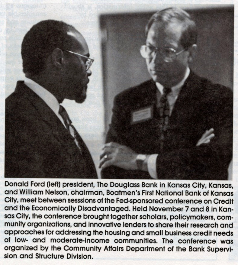 Black and white photo of two men in discussion
