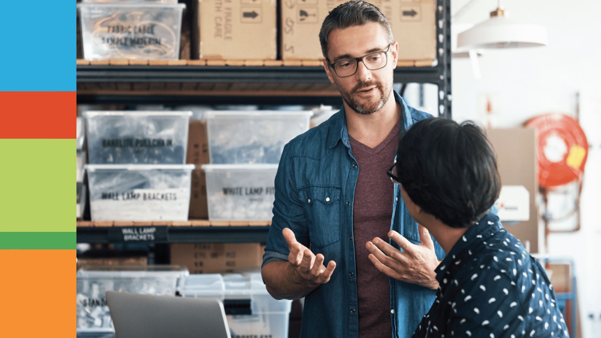 Two people stand in storage room