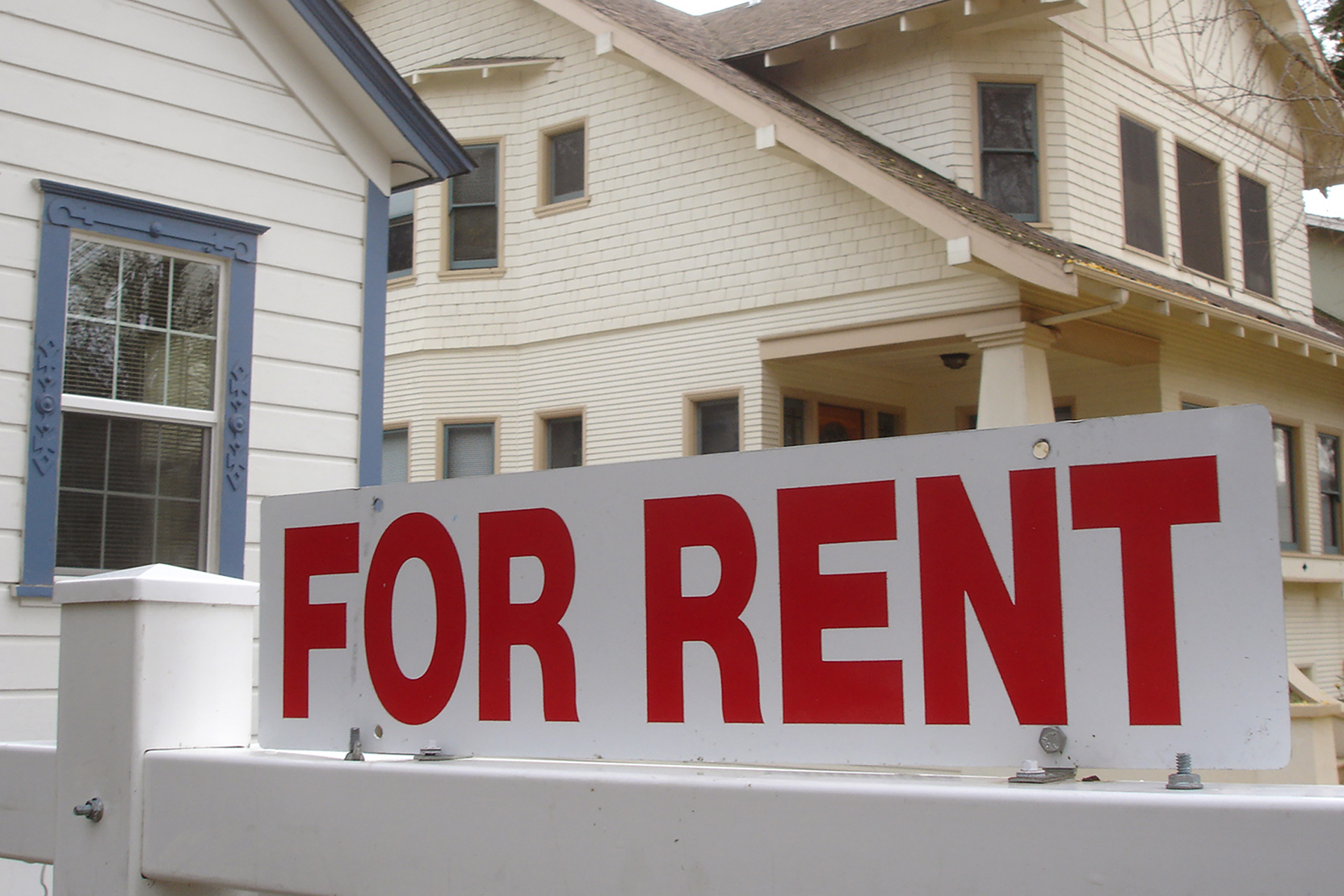 For Rent sign in front of houses.