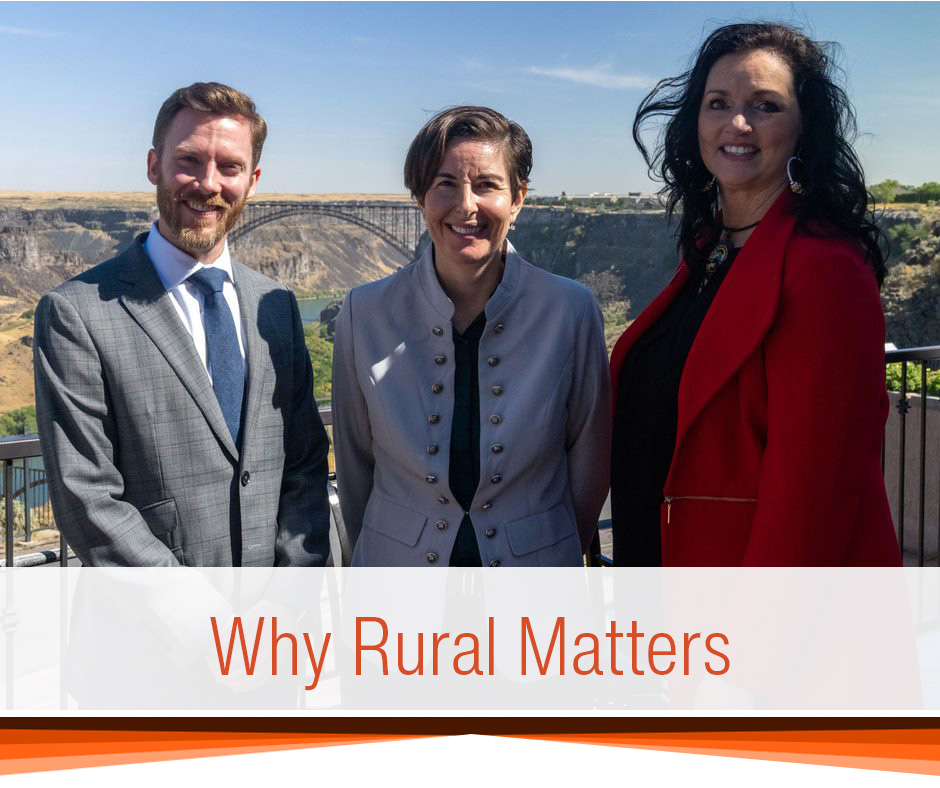 Three people smiling outside in rural Idaho